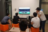 Both the contestants and Cosmos enjoying the excitement from the video game in the E-sports Competition